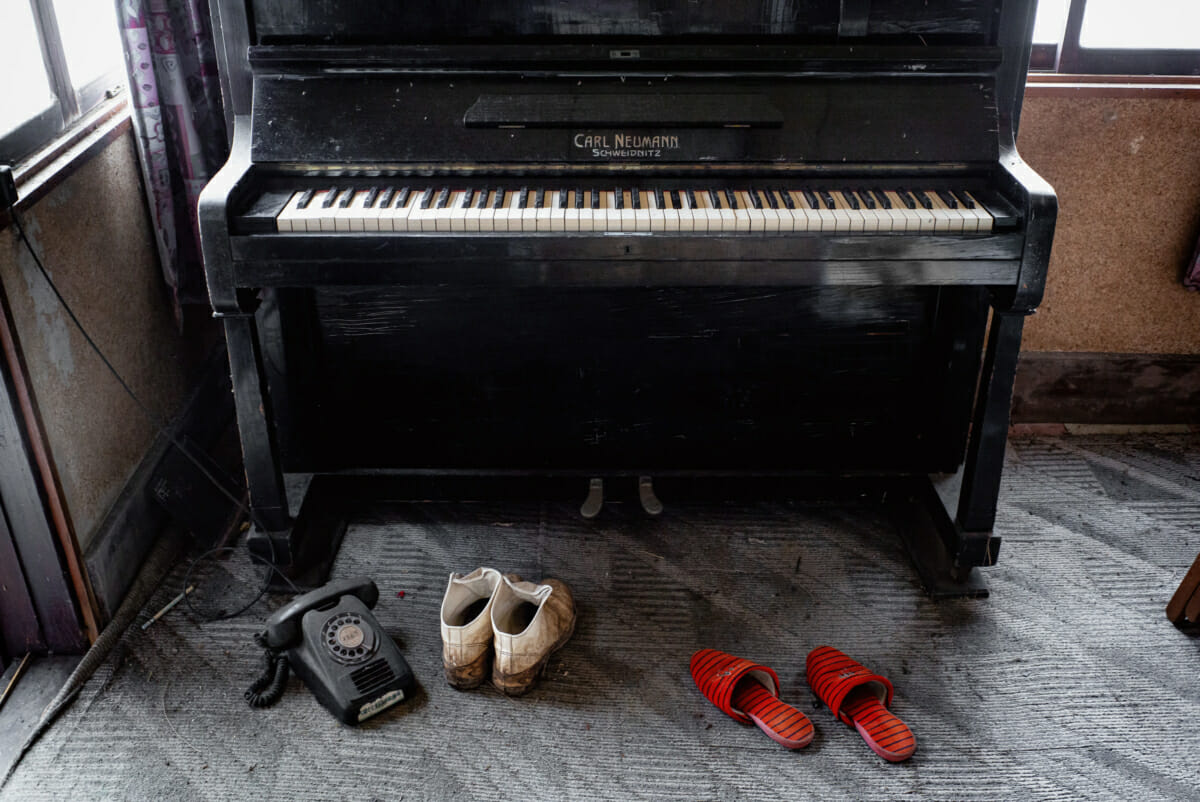 a silent piano in an abandoned tokyo house