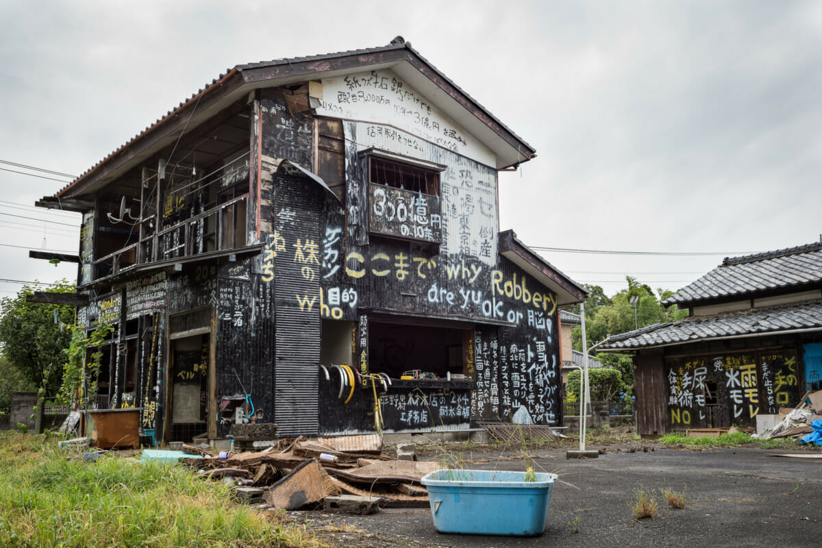 a dilapidated and kanji daubed Japanese house