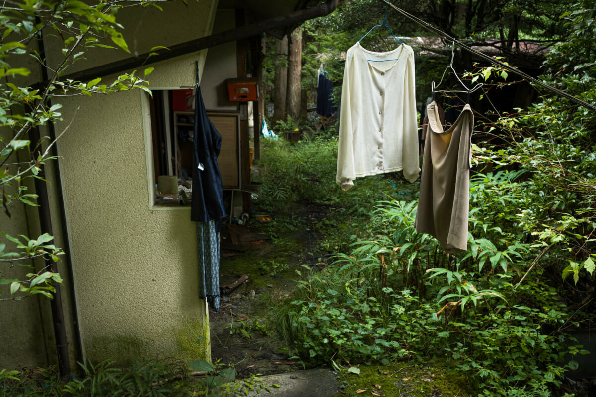 discarded clothes outside an abandoned Japanese home