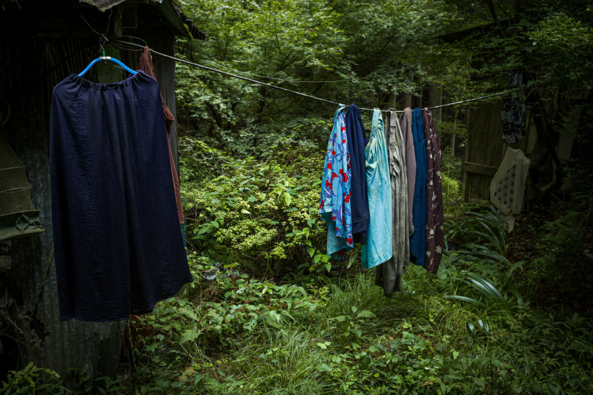 discarded clothes outside an abandoned Japanese home