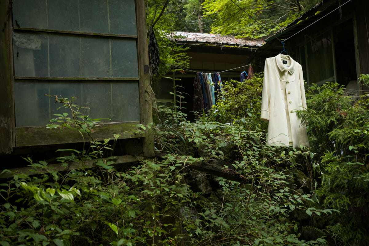 discarded clothes outside an abandoned Japanese home