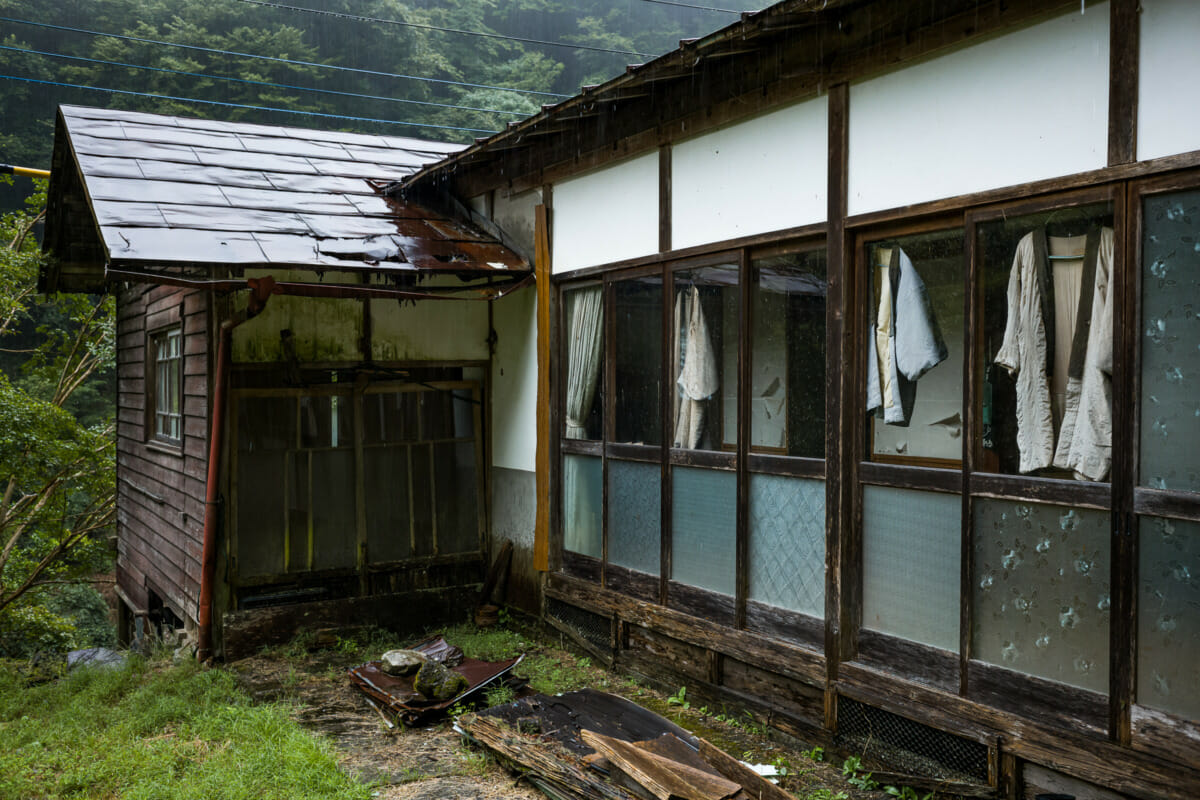 discarded clothes outside an abandoned Japanese home