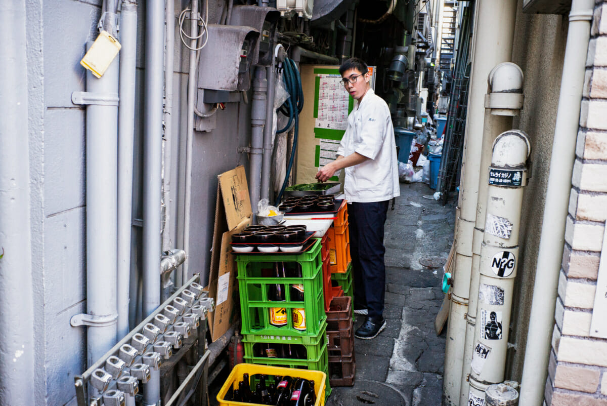 A Japanese chef working in a dirty Tokyo alleyway