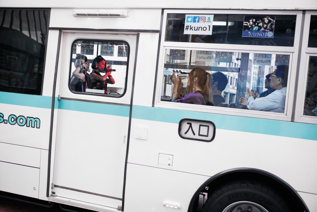 A Japanese girl group performing live on a Tokyo bus