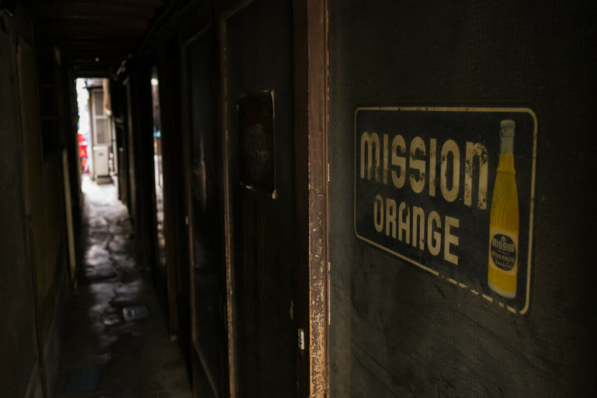 The rust and broken vending machines of an old Tokyo liquor store