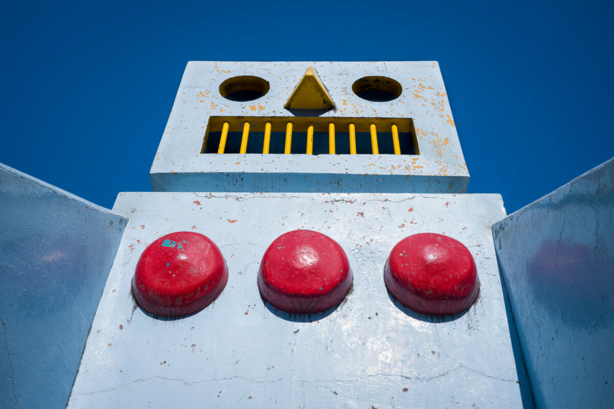 A large and retro concrete robot in an urban Tokyo park