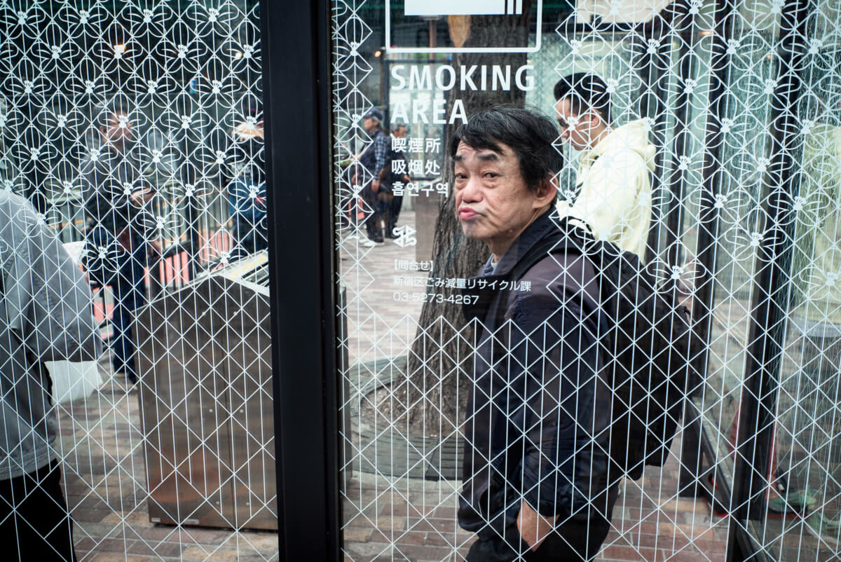 expressive Tokyo face in a smoking space