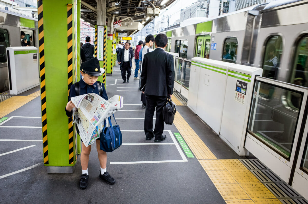 Japanese boy reading a newspaper